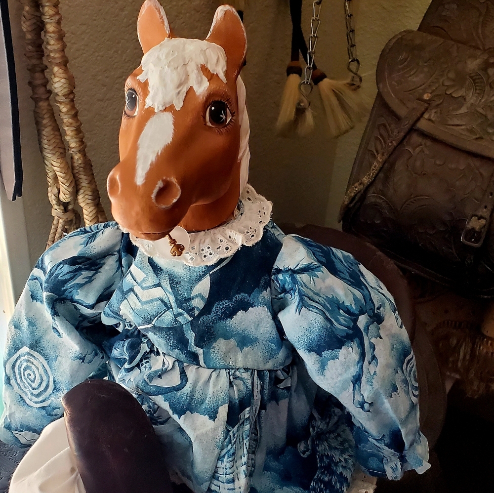 Ceramic, folk art hand painted horse doll with hooves wearing a blue dress